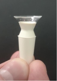 Contact lens placed in a lens device held by pinched fingers