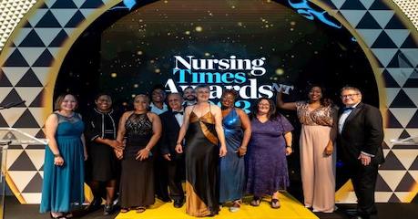 Group of people standing on stage at the nursing times award 2023