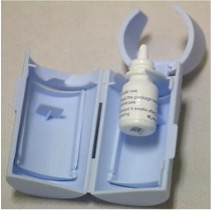 Eye drops bottle placed in an insertion aid