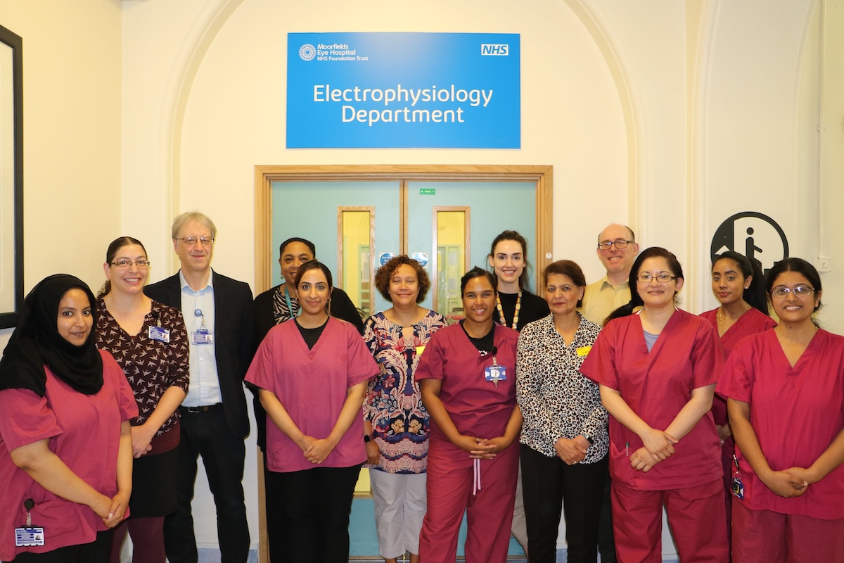 Electrophysiology award team standing together in the corridor outside the ward doors