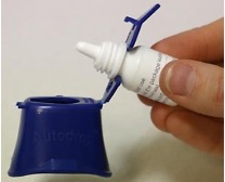 Eye drops bottle placed in an insertion aid