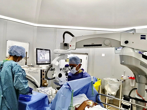 Medical team in a surgical theatre undertaking cataract surgery