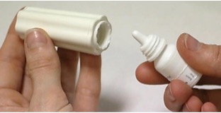 Eye drops bottle being placed in an insertion aid