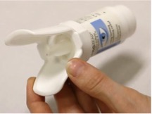 Eye drops bottle placed in an insertion aid