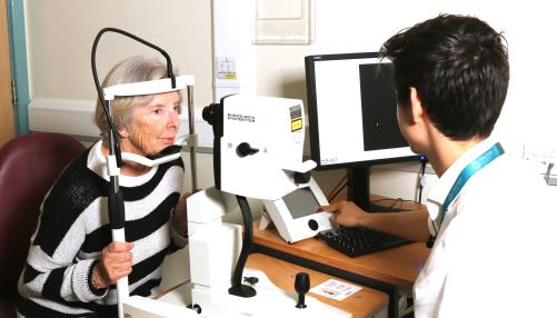 Patient having their eyes examined, using ophthalmological technology, by a consultant