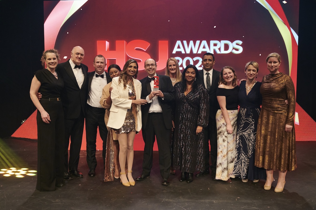 Group of people standing in a stage for Acute Sector Innovation Of The Year awards