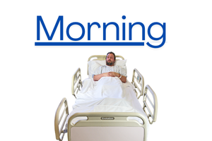 Person in a hospital bed with the rails up and the word 'afternoon' written and underlined above their head. 