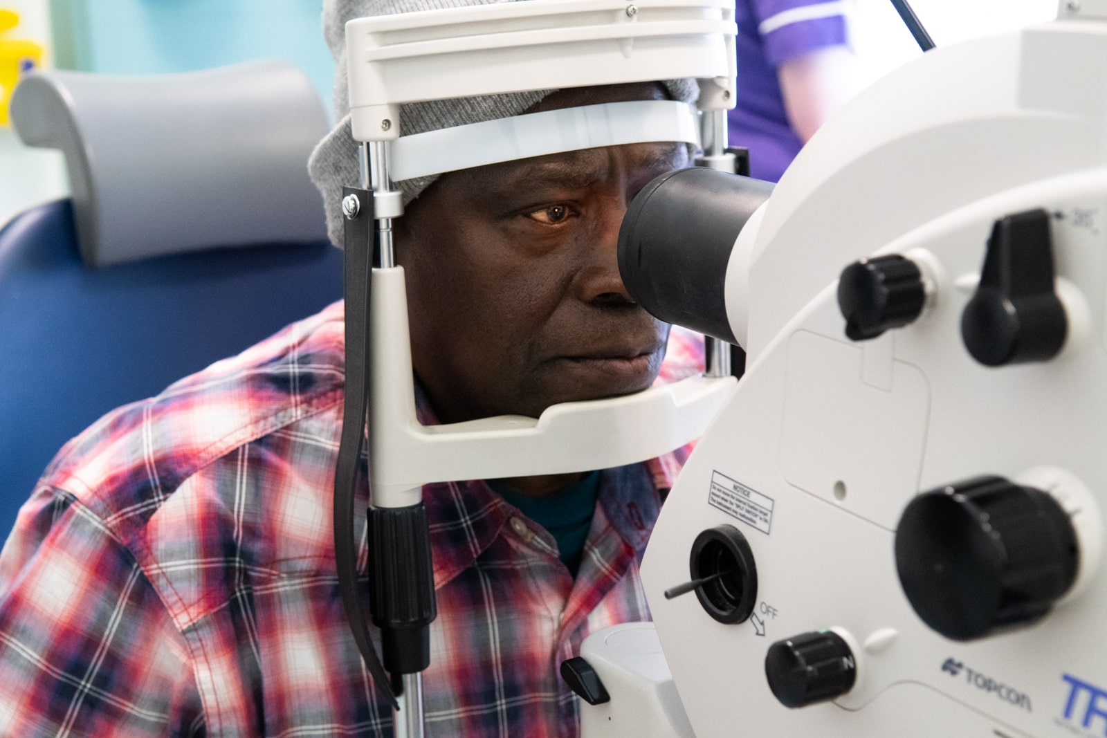 Patient having eye exam with ophthalmological equipment