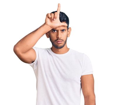 Person wearing a white t-shirt looking to camera using their hand to make an 'L' shape on their forehead