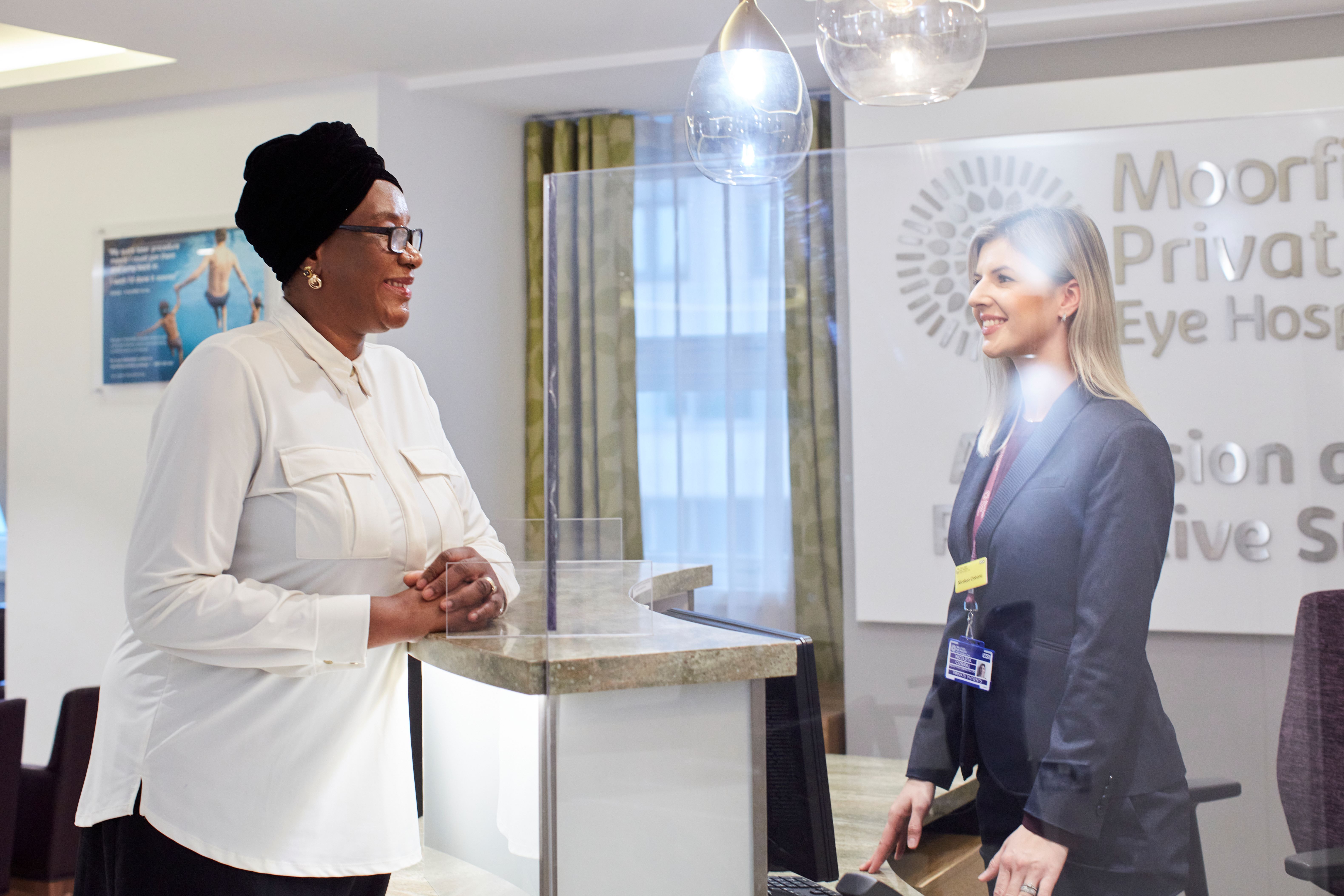 Photo of a consultant being greeted by a receptionist 