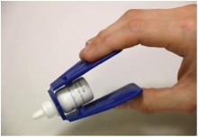 Eye drops bottle placed in an insertion aid