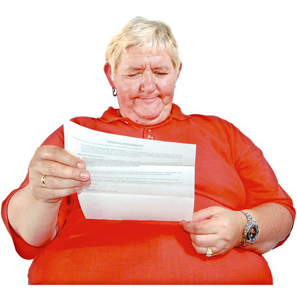 Person in a red top reading a piece of paper